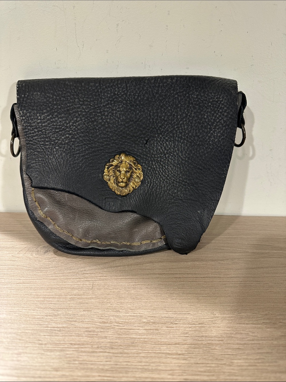 Black Leather Crossbody Bag with Gold Lion Accent